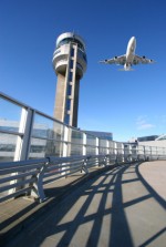 Airplane Flying Over Air Control Tower